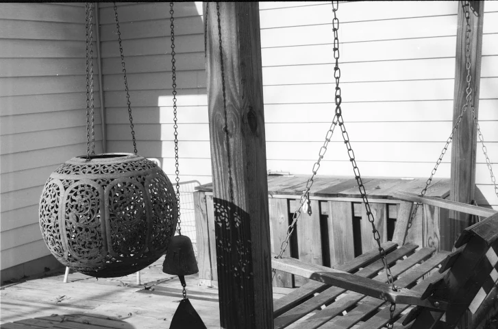 Intricate Light and Shadows of a Hanging Pot and a Swing